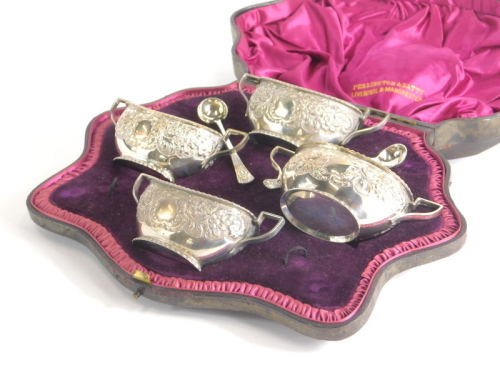 A set of four Victorian silver salts, each repousse decorated with angular handles with two associated spoons in fitted case marked Penlington & Batty Liverpool & Manchester, Sheffield probably 1895, 8oz all in. (cased)