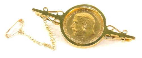 A George V full gold sovereign, 1918, in a brooch setting with plain pin back, 6cm wide, 11g all in.