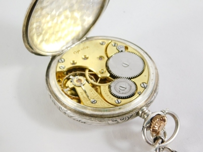 An early 20thC Omega open faced pocket watch, with 5cm diameter Arabic dial, subsidiary second hand, in repousse decorated case, marked 0.900, numbered 501B170, with Omega twelve disc back plate, graduated Albert watch chain with T bar end, 31cm long, 122 - 2