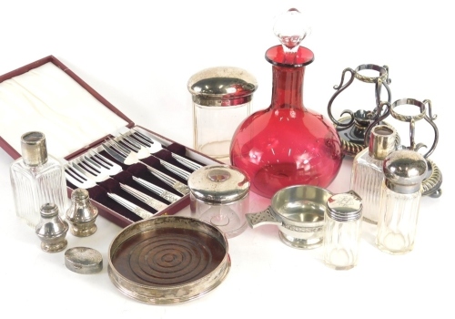 Various silver and effects, George V glass hair pot with silver lid, Birmingham 1921, 6cm high, various other cut glass jars, some with silver tops, cranberry glass decanter, cased plated forks, plated stands, silver bottle coaster with oak centre, etc. (