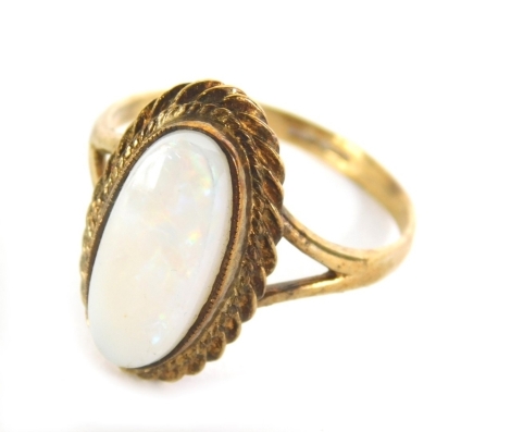 A dress ring, set with oval opal on part pierced shank, indistinctly marked, size R.