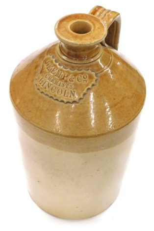 An early 20thC two coloured stoneware flagon, raised with J Kemp and Co Chemists Lincoln, with strap handle, 34cm high.