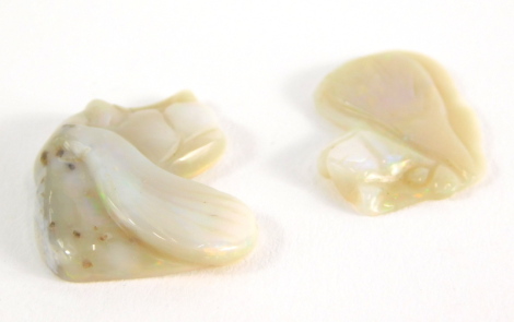 Two carved opal dogs heads, 2cm and 1.5cm high, 2.9g all in.