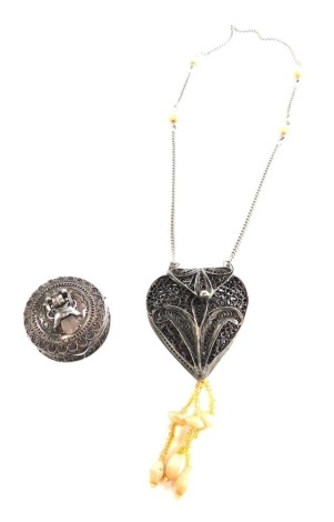 A filigree pill box, 3cm diameter, and a necklace. (2)