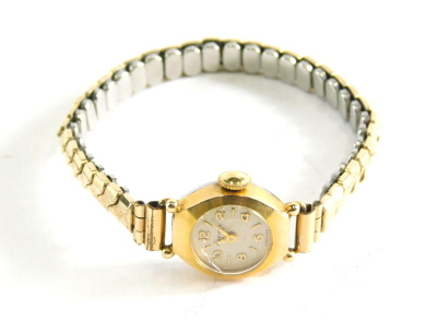 A Primax ladies wristwatch, the small circular watch head with numeric dial, in a gold plated and stainless steel backed case, on an expanding gold plated bracelet.