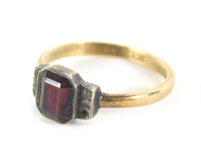 A dress ring, Art Deco style, set with garnet and marcasite stones, in white metal, with stepped shoulders on a plain band, yellow metal marked 9ct and silver, ring size M, 2.1g all in.