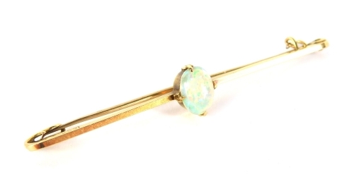 An opal bar brooch, the oval opal in a four claw setting, on a single bar, yellow metal stamped 15ct, 5.5cm wide, 2.4g all in.