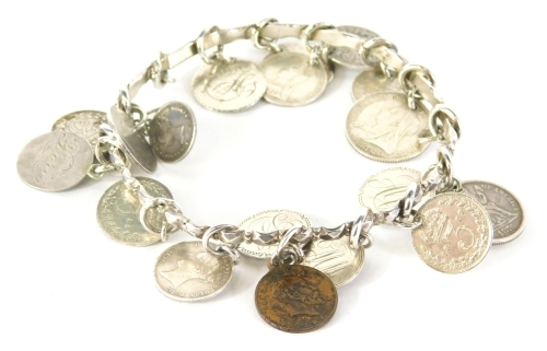 A silver coin bracelet, the bangle of hammered design, with various applied coin drops, 47.9g all in. Provenance Colston Family, South Scarle Hall.