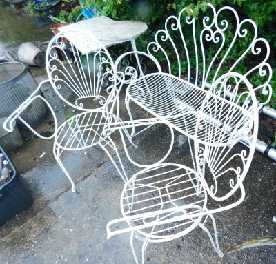 A suite of three white painted wrought iron garden set, comprising a two seat sofa with fan shaped back and two associated armchairs.