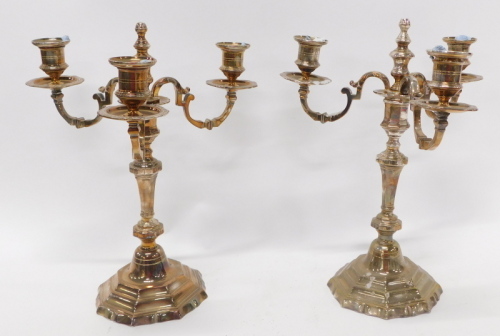 A pair of early 20thC three branch candelabra, each with urn dish holders on turned stems and stepped feet, 36cm high. (2)