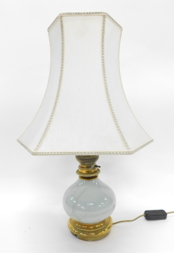 A pottery table lamp with material shade, 64cm high.