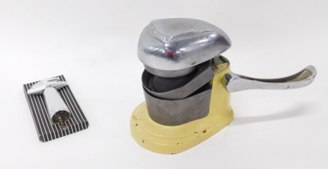 A vintage Atlantic lemon squeezer, on metal base in yellow and chrome plate, 25cm high, and a further vintage corkscrew.