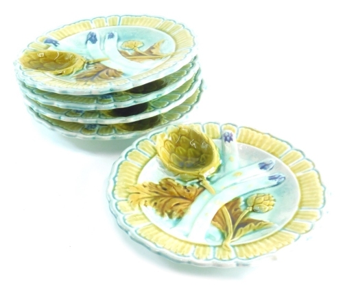 A set of five early 20thC Majolica plates, decorated with flower heads unmarked, 24cm wide.