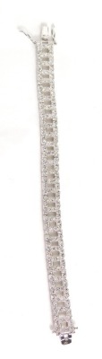 A silver tennis bracelet, set with imitation diamonds, each with a box link and slide in double clip clasp, 19cm long overall, 18.2g all in.