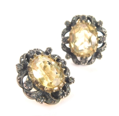 A pair of citrine earrings, the oval faceted citrine in a fan design outer frame, with silver and marquise set outer orders, with yellow metal coloured clip back, unmarked, 12.4g all in.