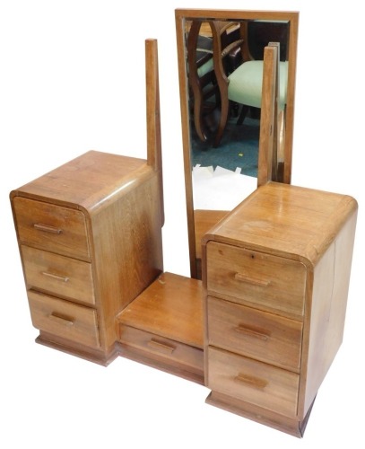 An Art Deco teak dressing table, with long rectangular mirror, above a short drawer flanked by three further drawers to each pedestal, on a plinth, 111cm wide.