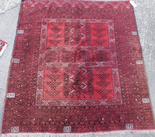 A Pakistani Turkoman rug, with a geometric design of latchhook medallions, etc., on a red ground with multiple borders, 172cm x 160cm.