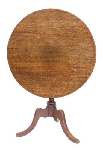 A 19thC oak occasional table, the circular tilt top, on a turned column, on tripod base, 87cm diameter.