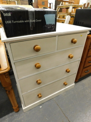 A painted pine chest of two short and three long drawers, on a plinth.