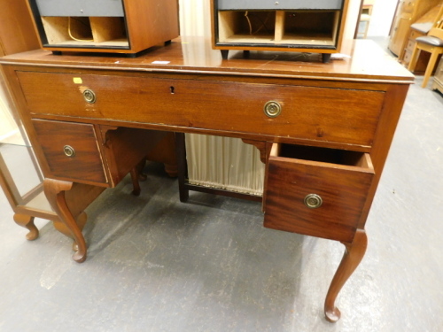 A mahogany dressing table with three drawers on cabriole legs.