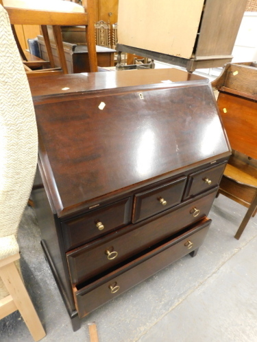 A Stag mahogany bureau with an arrangement of three short and two long drawers.