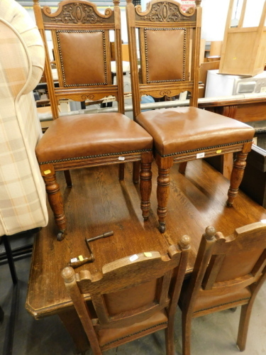 A late Victorian oak extending dining table, on square tapering legs and four similar chairs.