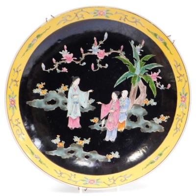 A Japanese Imari charger, decorated with dragons, etc., in typical colours (AF), 40cm diameter, and another Oriental charger, decorated with figures on a black ground within a yellow floral border, 40cm diameter. - 5