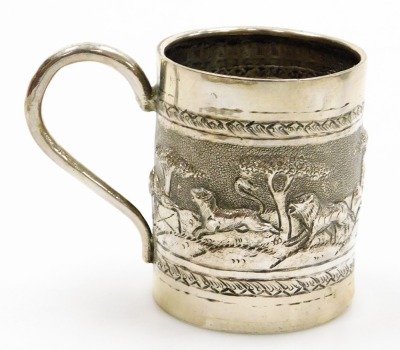 A collection of Oriental silver coloured metalware pieces, to include a goblet with embossed and repousse decoration of buildings, figures, etc., a similar bowl, small mug with a hunting scene, stamped T90, parasol handle, and trefoil dish, etc. (6) - 7