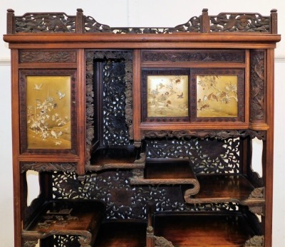 A Japanese Meiji period carved wood cabinet, elaborately decorated with birds, scrolls, flowers, etc., the sliding and hinged doors inset with Shibayama panels on gold lacquer ground with birds and flowers in mother of pearl and ivory on a bulbous base wi - 2