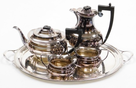 An Elizabeth II silver four piece tea set and two handled tray, the tea set of baluster form, comprising teapot, hot water jug, two handled sugar bowl and milk jug, J B Chatterley & Sons Ltd, Birmingham 1976, 114oz gross.