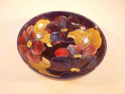 A Moorcroft circular bowl decorated with lilies on a blue ground