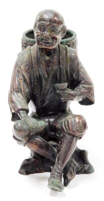 A Japanese bronze figure, Meiji period, modelled in the form of a man holding a gourd and a cup, whilst carrying a basket, unsigned, 17cm high. (AF) - 2