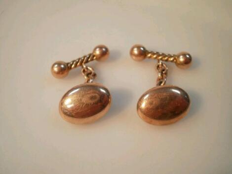 A pair of 10ct gold oval cuff links