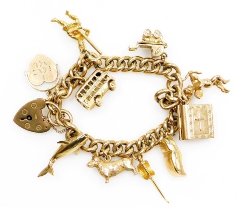 A 9ct gold curb link charm bracelet, with charms as fitted, on a heart shaped padlock clasp, 34.6g all in.