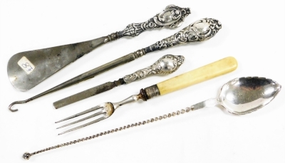 A group of white metal and silver mounted items, to include a shoe horn, white metal tea spoons with shaped elephant handle, silver handled button hook with repousse decoration, etc. (a quantity) - 4