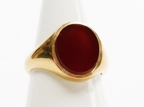 A 9ct gold gentleman's signet ring, with oval crest set with orange agate, London 1956, ring size O½, 7.1g all in, boxed.