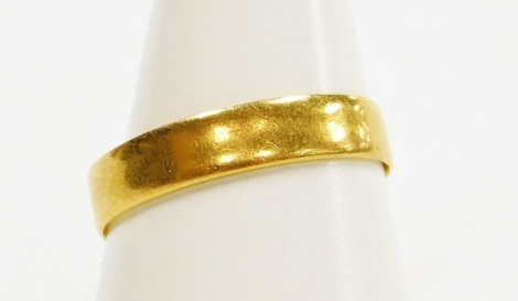 A 22ct gold wedding band, of plain design, London 1967, ring size P½, 2g all in.