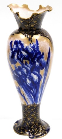 A Royal Doulton porcelain vase, with a flared wave rim, tapering body on a shaped foot, the body decorated with irises, against a sponged gilt body and blue and gilt highlighted neck and base, printed mark, 42cm high.