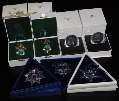 A group of Swarovski Crystal, comprising two angel Christmas tree decorations, boxed, Christmas ornaments for 2000, 2002 and 2003, and two glass plaques depicting male and female, dated 2000 and 2001.