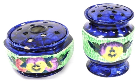 Two Ringtons Maling ware posy holders, in blue glaze decorated with a band of pansies against a green ground, 10cm high and 16cm high.