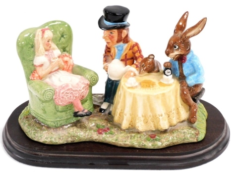 A Royal Doulton Beswick ware 'The Mad Hatters Tea Party' figure group, modelled by Martyn C.R. Alwick, limited edition number 159/1998, produced in 1998, on a hardwood base, the figure group 20cm wide.