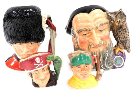 Two Royal Doulton character jugs, comprising The Guardsman D6755 and Merlin D6529 and two smaller examples, Long John Silver D7138 and The Golfer D6865. (4)