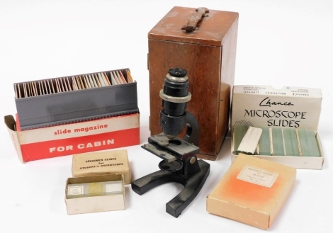 A student's microscope, in wooden case, the microscope 18cm high, and a quantity of slides, to include repaired slides of plants, slide magazine for cabin, etc. (a quantity)