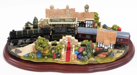 A Lilliput Lane 'The Royal Train At Sandringham' group, edition number 2377, on a hardwood base, 33cm wide overall.