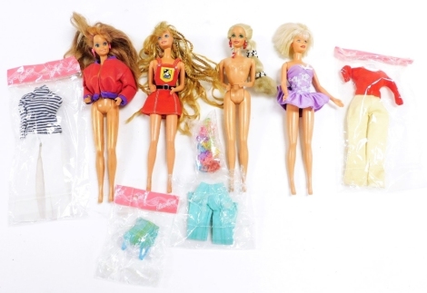 Four Mattel Barbie dolls, with various clothing.