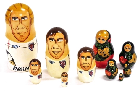 A set of five commemorative England 2006 World Cup nesting dolls, comprising Beckham, Lampard, Gerrard, Terry and Rooney, largest 15cm high, and a set of five traditional Russian nesting dolls, in blue and red decorated with cherries, largest 9cm high.