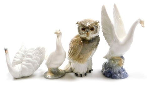 Three Nao porcelain bird figures, comprising owl, 17cm high, swan, 19cm high, goose, 15cm high and a Lladro swan, 10cm high, in associated boxes.