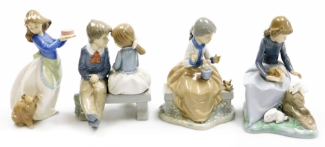 Four Nao porcelain figure groups, comprising girl holding birthday cake with dog, 19cm high, two children sat on bench, 16cm high, girl sat on garden seat with birds and flower pots, 17cm high and girl sat on fallen tree stump with rabbits, 18cm high, all