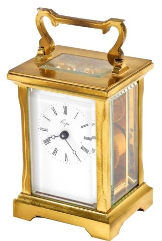 A 20thC brass carriage clock, for Cope, enamel dial bearing Roman numerals, single barrel movement, in a typical case with carrying handle, 11cm high, with key.