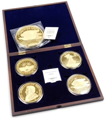 A United States Liberty gold plated copy 1933 twenty dollars coin, together with four Gold Giants commemorative United States 20 dollar coins, with certificates, boxed.